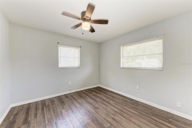 unfurnished room with wood finished floors, baseboards, and a ceiling fan