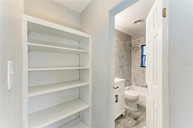 bathroom featuring bathtub / shower combination, vanity, marble finish flooring, and toilet