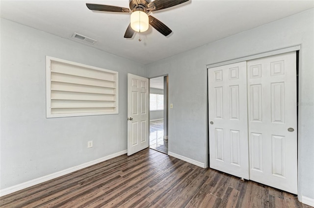 unfurnished bedroom with wood finished floors, baseboards, a closet, and ceiling fan