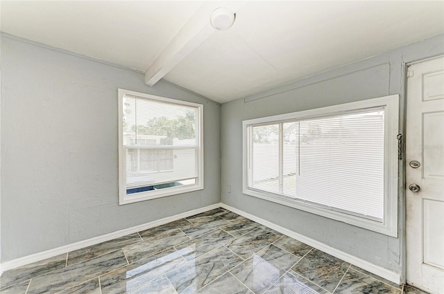 unfurnished room featuring baseboards