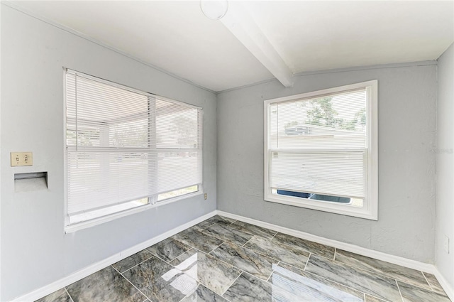 unfurnished room featuring baseboards