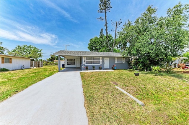 view of front of property with concrete driveway and a carport