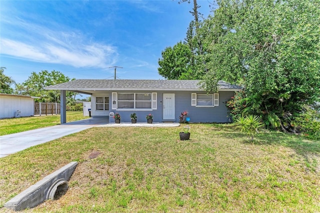single story home with driveway, a carport, and a shingled roof