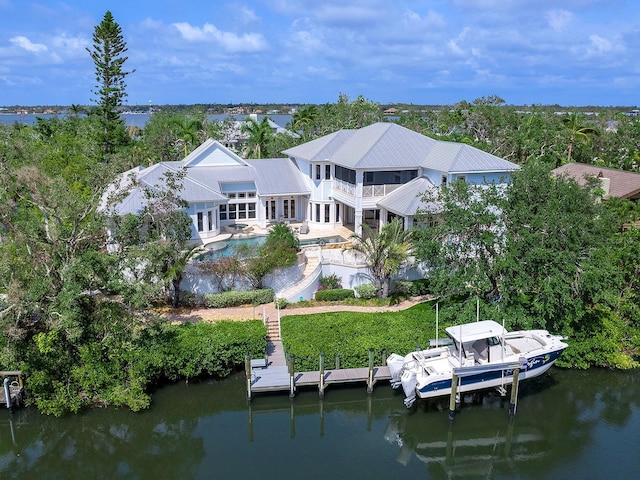 5132 Jungle Plum Rd, Sarasota, FL 34242 - rear view of property featuring an outdoor pool, a water view, a patio, a balcony, and metal roof