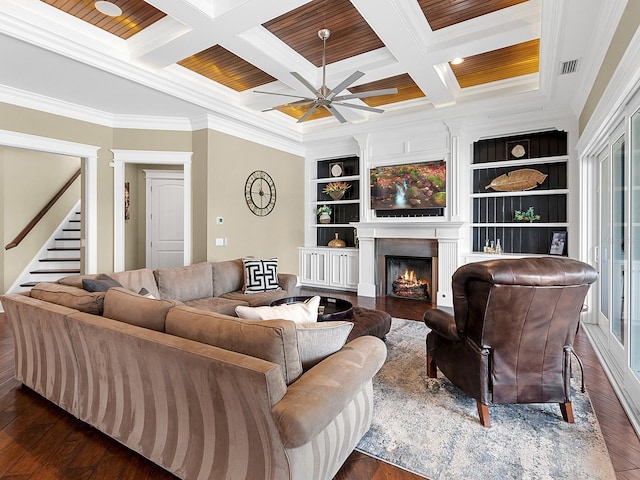 5132 Jungle Plum Rd, Sarasota, FL 34242 - living area featuring dark wood-style floors, crown molding, a warm lit fireplace, ceiling fan, and beamed ceiling