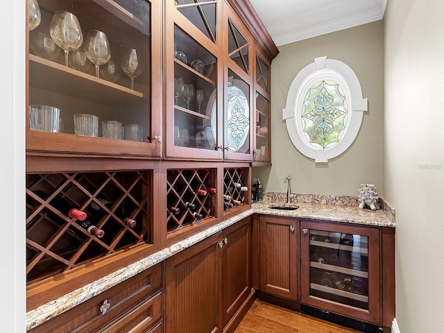 5132 Jungle Plum Rd, Sarasota, FL 34242 - indoor wet bar featuring wine cooler, ornamental molding, and light wood-style floors