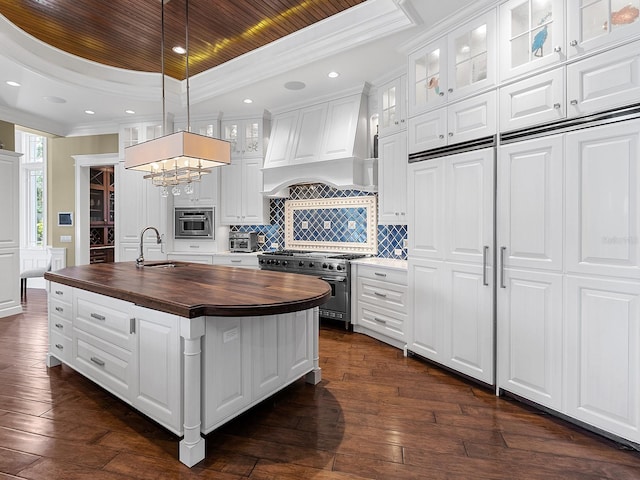 5132 Jungle Plum Rd, Sarasota, FL 34242 - kitchen featuring wooden counters, high end stove, a raised ceiling, custom exhaust hood, and a sink
