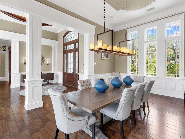 5132 Jungle Plum Rd, Sarasota, FL 34242 - dining area with decorative columns, a decorative wall, a chandelier, dark wood-type flooring, and ornamental molding