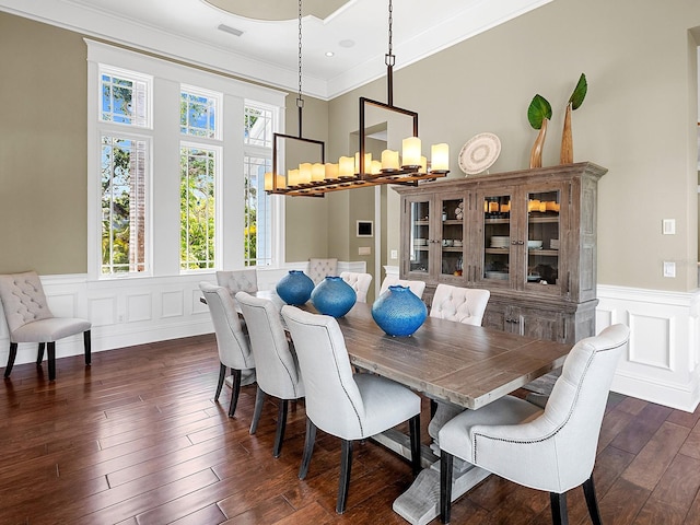 5132 Jungle Plum Rd, Sarasota, FL 34242 - dining room featuring a chandelier, dark wood finished floors, wainscoting, ornamental molding, and a decorative wall