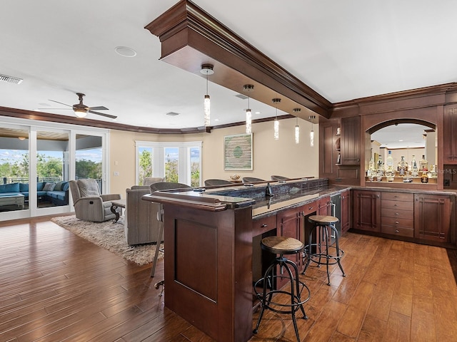 5132 Jungle Plum Rd, Sarasota, FL 34242 - indoor bar featuring crown molding, wood-type flooring, ceiling fan, and hanging light fixtures