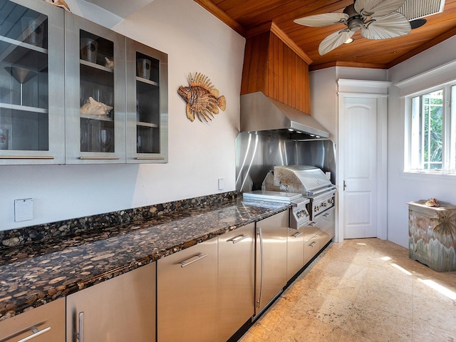 5132 Jungle Plum Rd, Sarasota, FL 34242 - kitchen with wooden ceiling, exhaust hood, glass insert cabinets, dark stone counters, and a ceiling fan