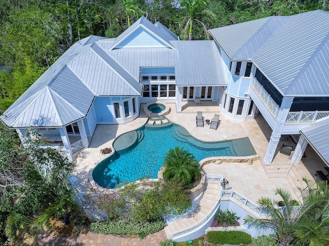 5132 Jungle Plum Rd, Sarasota, FL 34242 - outdoor pool featuring french doors, an in-ground hot tub, and a patio