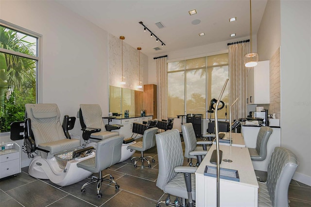 office featuring track lighting and visible vents
