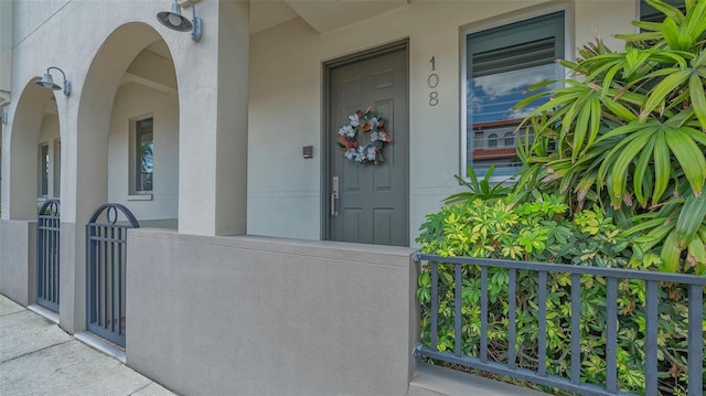 235 Cocoanut Ave Unit 108B, Sarasota, FL 34236 - doorway to property featuring stucco siding and covered porch