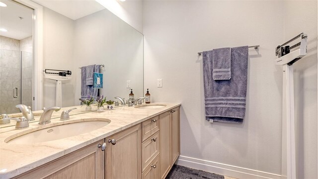 235 Cocoanut Ave Unit 108B, Sarasota, FL 34236 - bathroom with a shower stall, double vanity, baseboards, and recessed lighting
