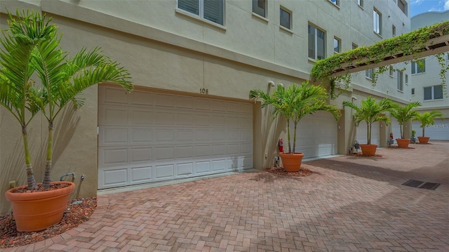 235 Cocoanut Ave Unit 108B, Sarasota, FL 34236 - garage featuring decorative driveway