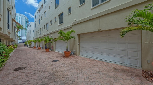 235 Cocoanut Ave Unit 108B, Sarasota, FL 34236 - garage featuring decorative driveway