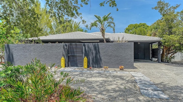 view of front of home with a tiled roof and fence