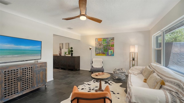 living area featuring a ceiling fan