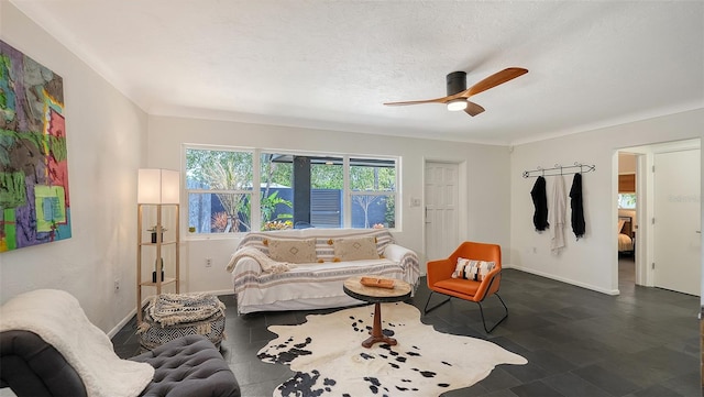 living room with a ceiling fan and baseboards