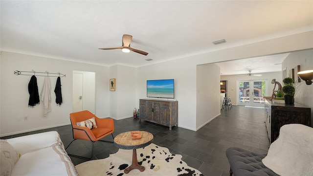 living area featuring a ceiling fan, french doors, and baseboards