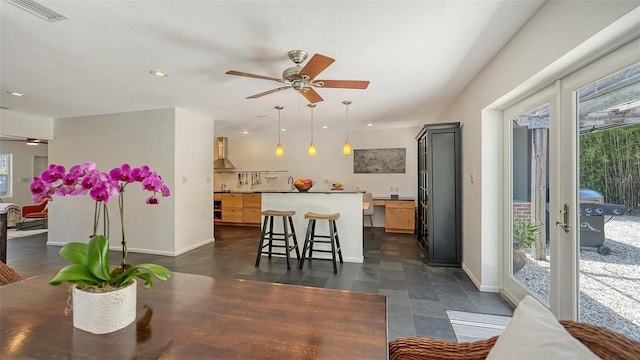 dining room with ceiling fan, baseboards, and recessed lighting
