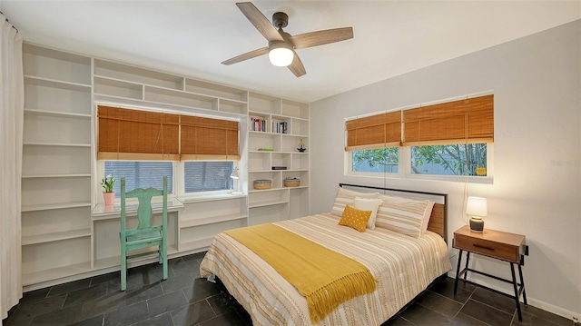 bedroom featuring ceiling fan and baseboards