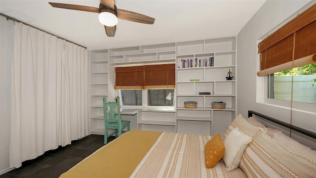 bedroom featuring dark tile patterned flooring and ceiling fan