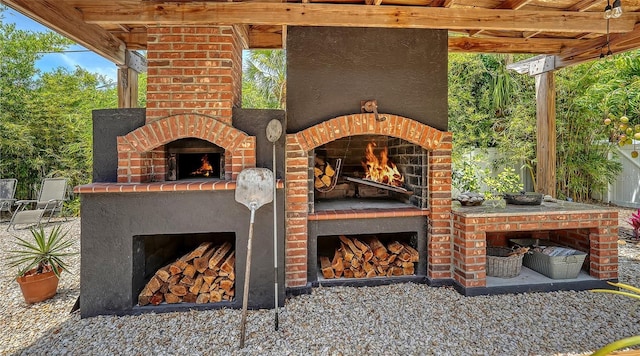 view of patio / terrace with an outdoor brick fireplace