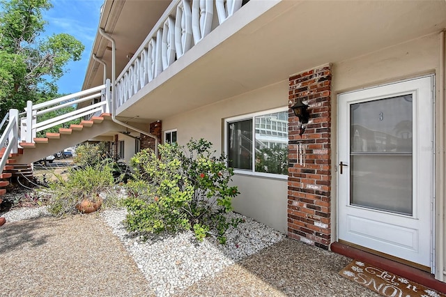 3705 S School Ave Unit 3, Sarasota, FL 34239 - view of property exterior featuring stairs and stucco siding