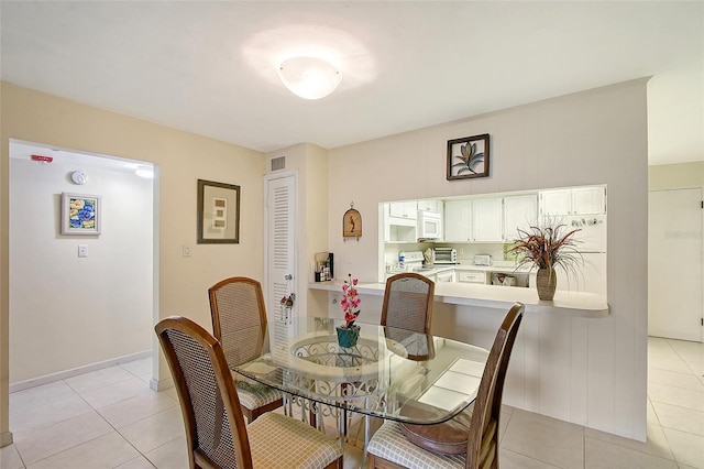 3705 S School Ave Unit 3, Sarasota, FL 34239 - dining space with light tile patterned floors and baseboards