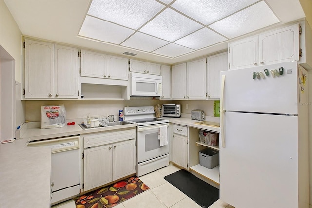 3705 S School Ave Unit 3, Sarasota, FL 34239 - kitchen with white appliances, open shelves, a sink, light tile patterned floors, and light countertops