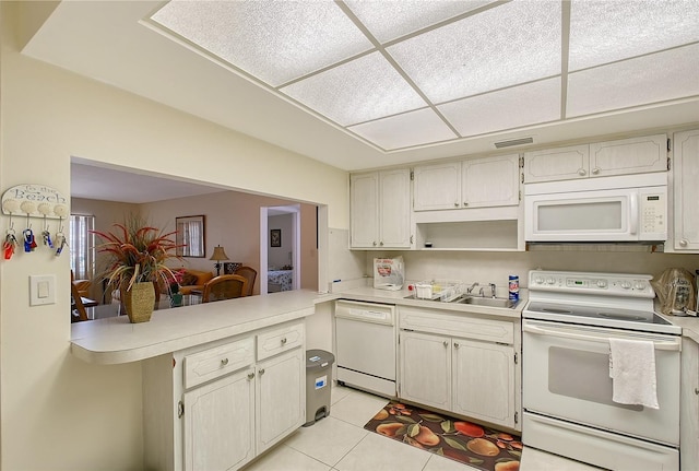 3705 S School Ave Unit 3, Sarasota, FL 34239 - kitchen with white appliances, light countertops, light tile patterned flooring, and a sink