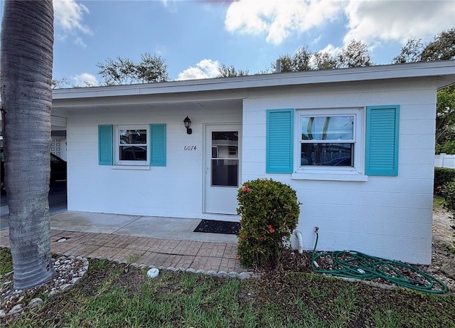 property entrance featuring concrete block siding