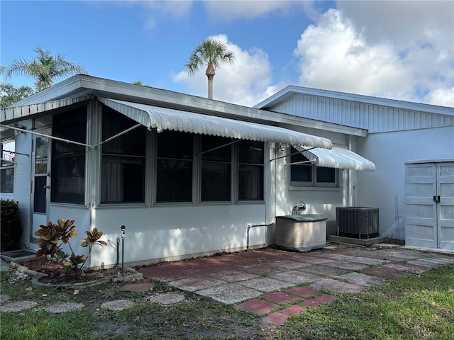 back of house featuring central air condition unit
