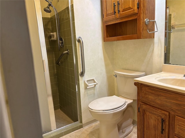 bathroom featuring a shower stall, toilet, vanity, and tile patterned floors