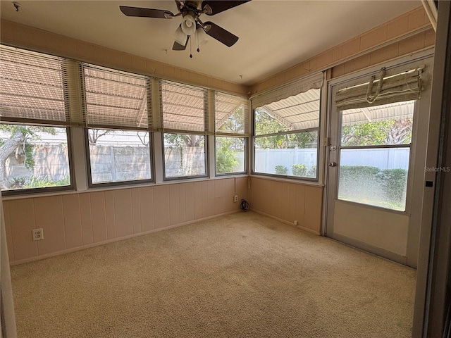 unfurnished sunroom with a ceiling fan