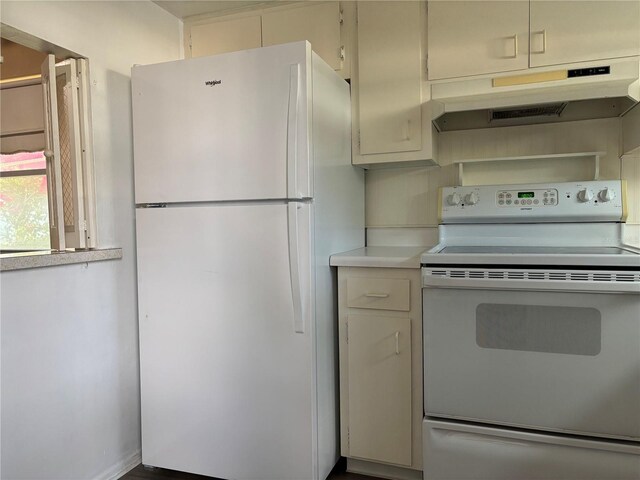 kitchen featuring white appliances, under cabinet range hood, and light countertops