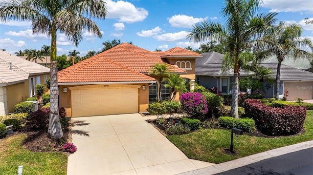20040 Rookery Dr, Estero, FL 33928 - view of front facade with stucco siding, an attached garage, concrete driveway, and a tile roof