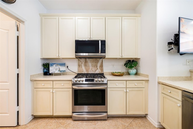20040 Rookery Dr, Estero, FL 33928 - kitchen with stainless steel appliances, cream cabinets, and light countertops