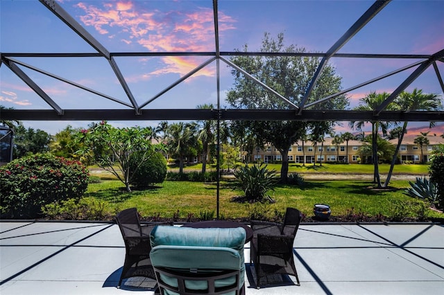 20040 Rookery Dr, Estero, FL 33928 - patio terrace at dusk featuring a yard and glass enclosure