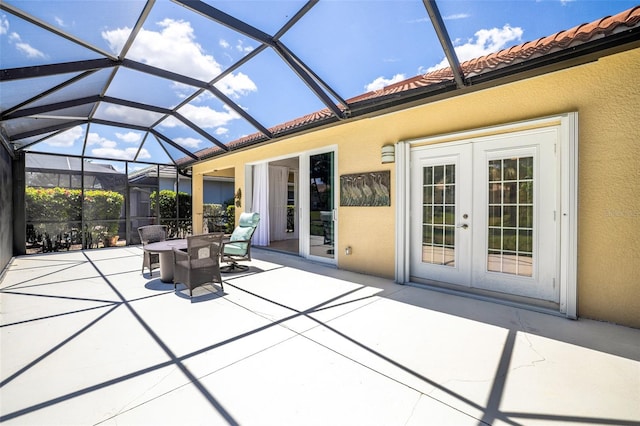 20040 Rookery Dr, Estero, FL 33928 - view of patio / terrace with french doors, outdoor dining space, and glass enclosure