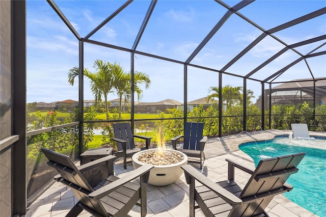 16226 Hidden Oak Loop, Bradenton, FL 34211 - view of patio with an outdoor fire pit, an outdoor pool, a lanai, and a water view