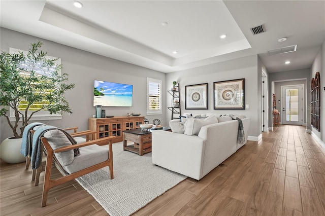 16226 Hidden Oak Loop, Bradenton, FL 34211 - living room featuring a raised ceiling, wood finished floors, recessed lighting, and baseboards