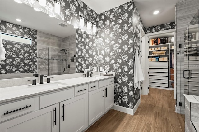 16226 Hidden Oak Loop, Bradenton, FL 34211 - full bath featuring wallpapered walls, a shower stall, wood finished floors, double vanity, and baseboards