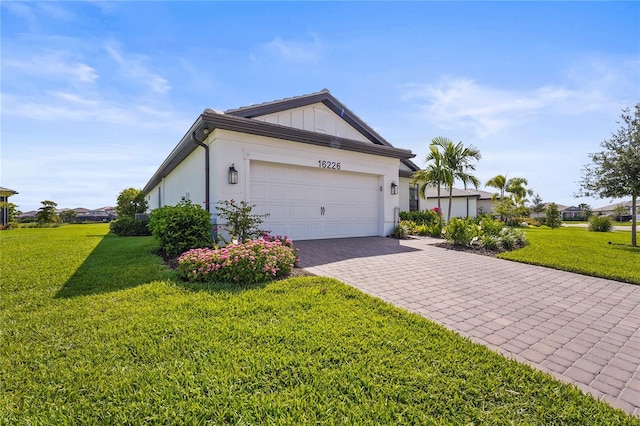 16226 Hidden Oak Loop, Bradenton, FL 34211 - view of front facade featuring decorative driveway, a front lawn, and a garage