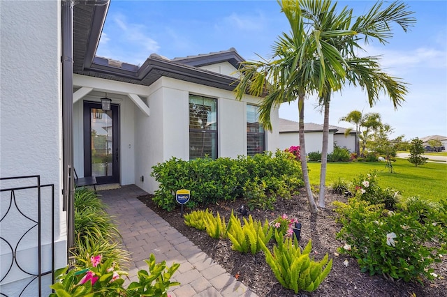 16226 Hidden Oak Loop, Bradenton, FL 34211 - property entrance featuring stucco siding and a lawn