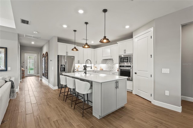 16226 Hidden Oak Loop, Bradenton, FL 34211 - kitchen with appliances with stainless steel finishes, baseboards, light wood-type flooring, and recessed lighting