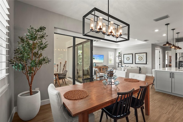 16226 Hidden Oak Loop, Bradenton, FL 34211 - dining area featuring light wood-style flooring, baseboards, a chandelier, and recessed lighting