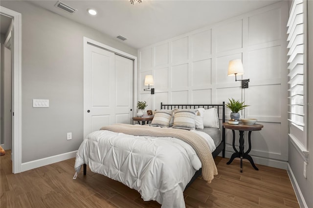 16226 Hidden Oak Loop, Bradenton, FL 34211 - bedroom with a decorative wall, a closet, wood finished floors, baseboards, and recessed lighting
